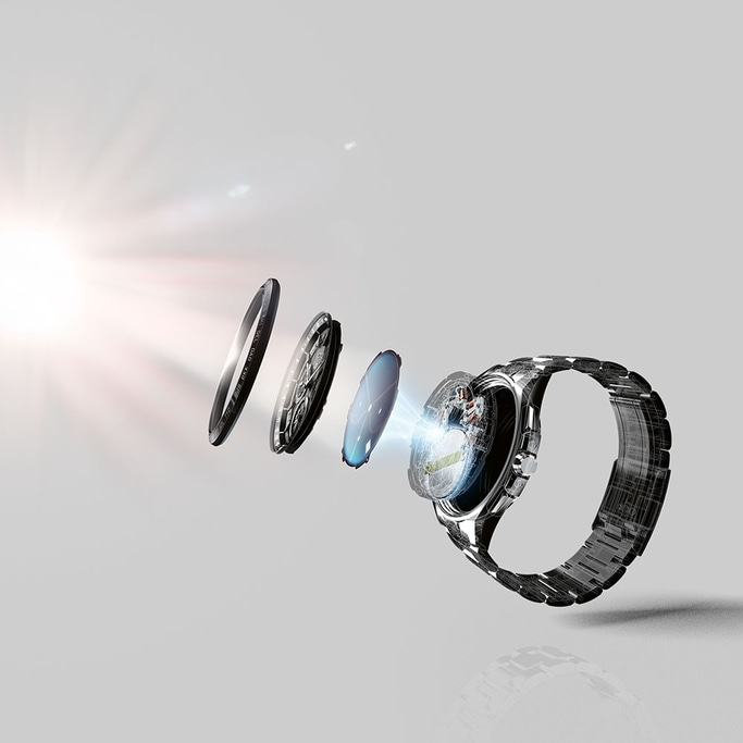 A silver wristwatch is disassembled in mid-air, showcasing its internal components, with a bright light illuminating the intricate mechanism.
